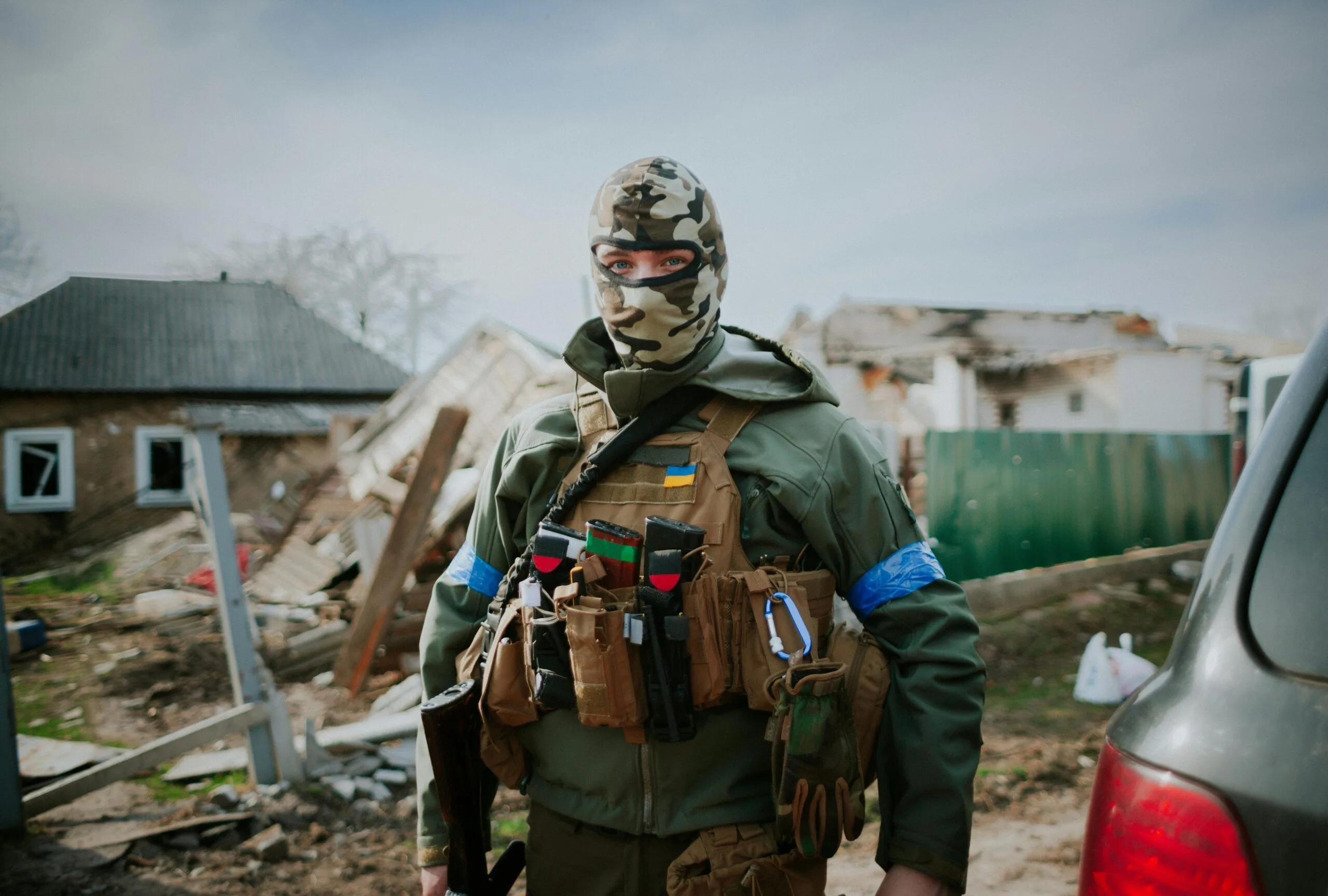 A Person in Green Jacket Wearing Camouflage Mask